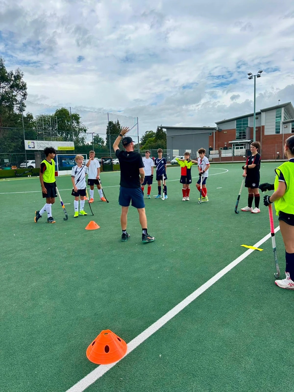 UK Sports Hockey coach leading a player development session