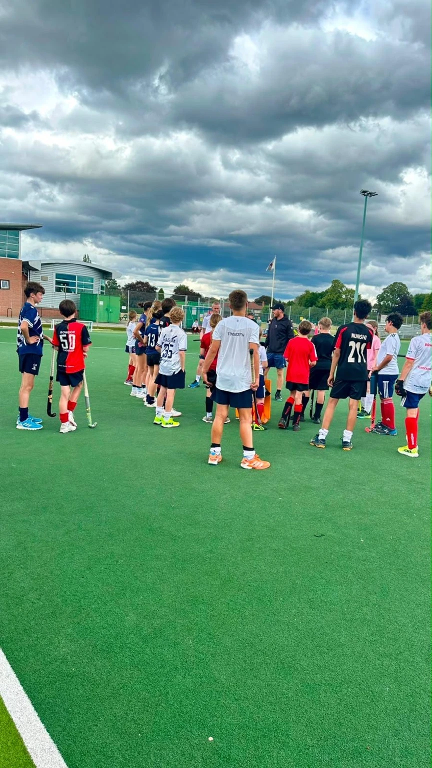 UK Sports Hockey players together during a group coaching session