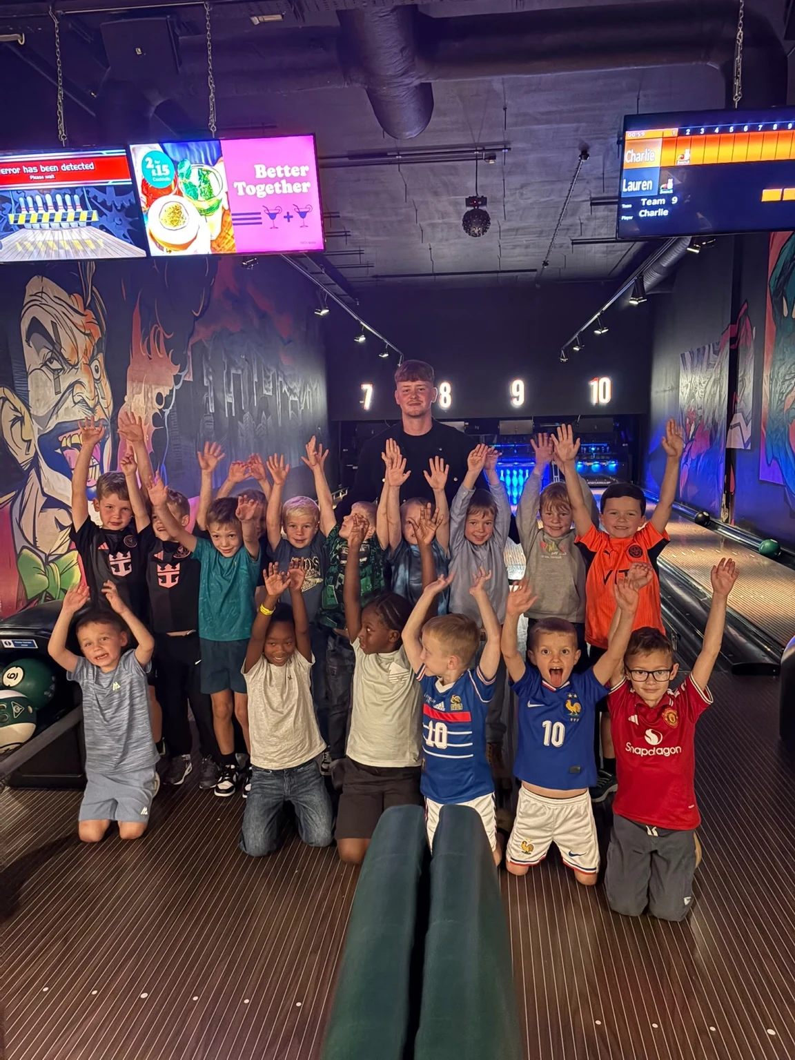 UK Sports FC U7s players enjoying a team bowling trip with their coach